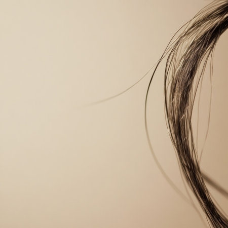 A broken strand of hair is captured in macro detail, showing textures and split ends against a neutral backdrop.の素材