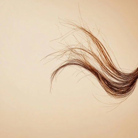A detailed view captures a broken strand of hair on a smooth surface, showing its delicate state and natural texture.の素材