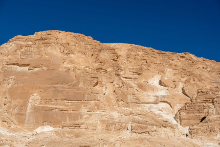 Rugged cliffs dominate the landscape of the Sinai desert in Egypt, showing impressive rock...