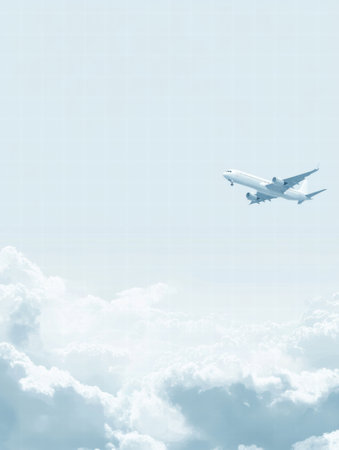 An airplane glides gracefully through a bright sky filled with soft, white clouds during daylight, showing the beauty of aviation.の素材