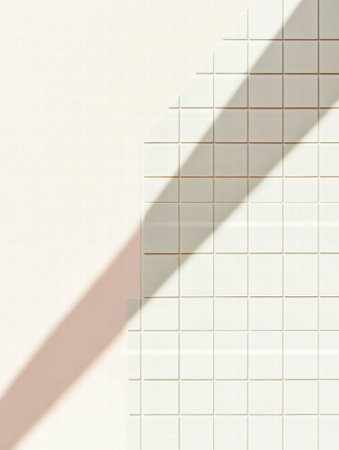 A strong diagonal shadow from an unseen object falls over a grid of white tiles, enhancing the geometric patterns in soft afternoon light.の素材