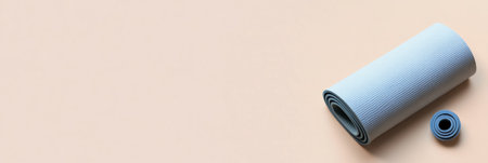 A minimalistic yoga mat lies diagonally against a light background, showcasing muted tones and ample empty space for a serene atmosphere.の素材