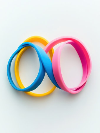 Three colorful fitness bands intersect at precise angles, creating an eye catching display of balance and simplicity on a white background.の素材