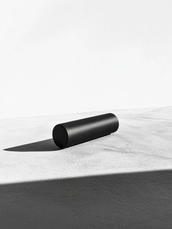 A single fitness roller rests on a flat surface, showing a minimalist design with ample negative space and a focus on simplicity.の素材