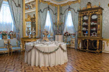 Intricately designed dining room at Great Peterhof Palace features luxurious furnishings, elaborate decorations, and a beautifully set table ready for guests.の写真素材