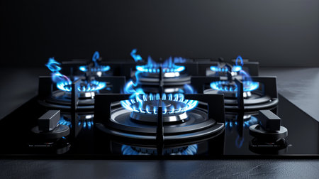 Horizontal view of kitchen gas stove burners emitting blue flames, illustrating rising gas prices amid ongoing economic challenges and energy concerns.の素材
