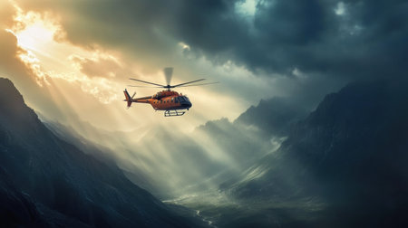 A rescue helicopter navigates the rugged mountain terrain as dramatic clouds and sunlight create a stunning backdrop at dusk.の素材