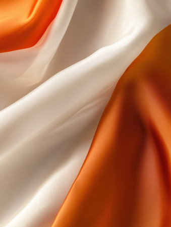 A national flag flutters gracefully in the wind, showing high-detail fabric texture and a clean design, illuminated by soft natural lighting.の素材