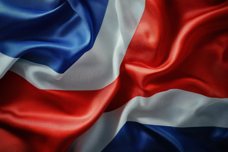 The national flag billows softly in the wind, showing its vibrant colors and high-detail fabric texture amid clean and minimalistic surroundings.の素材