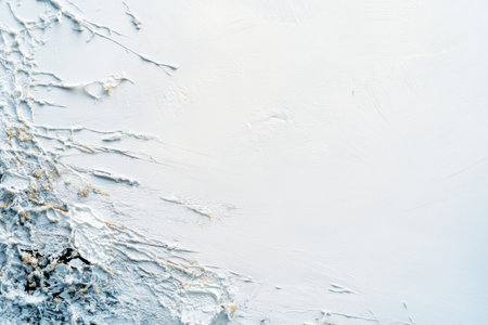 Gentle water splashes create an abstract design on a pristine white surface, enhanced by soft lighting that emphasizes its minimalistic beauty.の素材