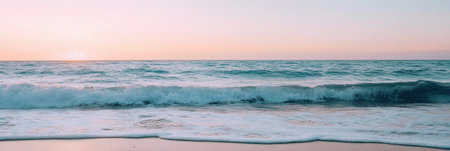 Gentle waves lap against the shore as a serene pastel sky transitions from night to day, inviting moments of peace and reflection by the ocean.の素材