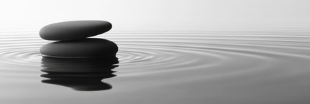 Gentle ripples create a serene atmosphere around stacked stones on calm water, showcasing a perfect blend of nature and minimalism.の素材