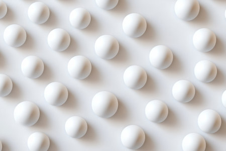 Structured patterns of evenly spaced matte white spheres create an elegant modern minimalism against a soft neutral background, enhancing visual simplicity.の素材
