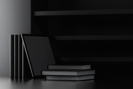 Elegant monochrome setup including stacked books and a sleek digital tablet against a soft gradient backdrop, perfect for academic focus and creativity.の素材