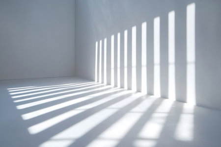 Light strips cast elongated shadows on a pristine white surface, forming a minimalist and abstract design typical of contemporary art environments.の素材