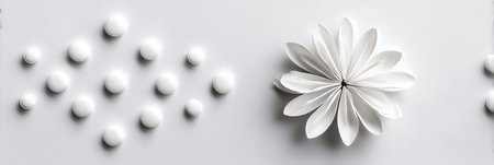 White pills are artistically arranged to create a blooming flower shape, representing wellness and minimalism on a clean, neutral background.の素材