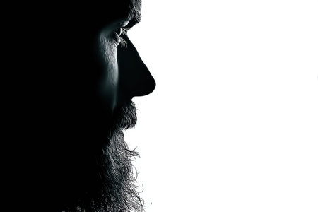 A side profile shows the detailed silhouette of a man with a prominent beard, set against a minimalistic white background creating a striking contrast.の素材