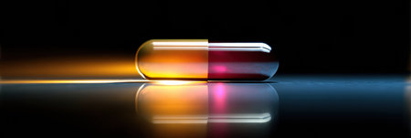 A single lifesaving pill glows under a focused beam of light, emphasizing its shape and colors against a dark background with reflectionsの素材