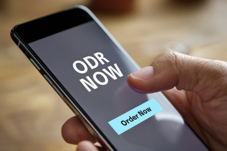 A hand is shown tapping the Order Now button on a smartphone screen. The clean and minimal design emphasizes the ease of placing an order digitally.の素材
