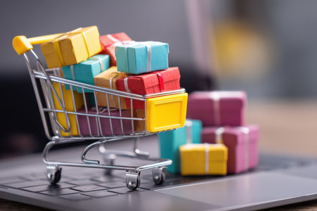 A shopping cart overflowing with vibrant gift boxes is positioned on a checkout screen, symbolizing the joy of online shopping during peak purchasing times.の素材