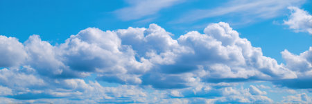 A vivid summer sky showcases an array of thin white clouds drifting gracefully across a tranquil pastel blue backdrop, creating a serene atmosphere.の素材
