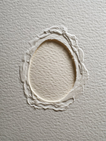 Textured recycled paper features a delicate pressed egg outline, highlighting the beauty of sustainable materials and creative artistry in modern design.の素材