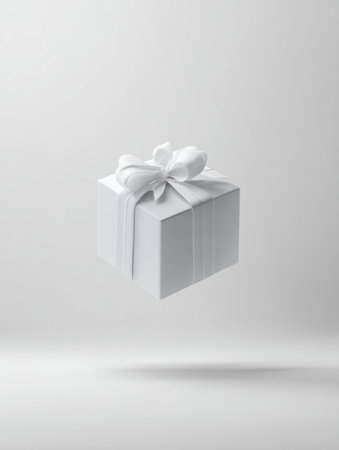A 3D gift box hovers effortlessly in a minimal white environment, symbolizing celebration and joy, ideal for events like birthdays or holidays.の素材