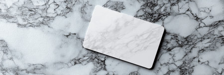 A sleek gift card mockup rests on a polished white marble surface, offering a clean design ideal for showcasing brand logos and personalized messages.の素材