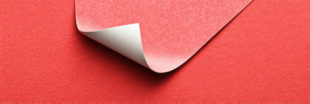 Price Label Sticker Partially Peeled on Vivid Red Surface Creating Interesting Texture and Color Contrastの素材