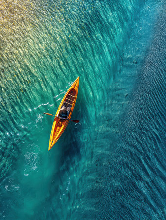 Gliding across a stunning glacier lake, the kayaker enjoys the tranquil ambiance created by vibrant blue waters and breathtaking surroundings.の素材