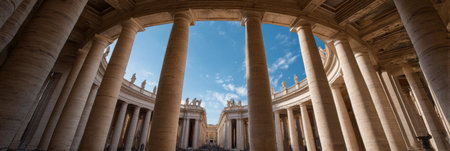 Clear blue sky frames the view through the colonnade of St Peters Square, highlighting the architectural beauty and serene atmosphere of Vatican City.の素材