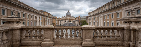 The marble balustrade frames a wide view of the Vatican dome against a backdrop of clouds, capturing the iconic architecture and atmosphere of the location.の素材
