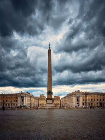 Vatican obelisk dominates St Peters Square under an overcast sky, creating a striking contrast against the historical architecture surrounding it.の素材