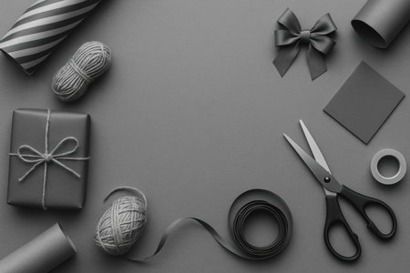 Various crafting supplies are neatly organized around a gift, including scissors, ribbons, and yarn, creating a cozy atmosphere for gift preparation.の素材