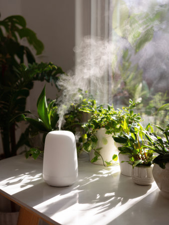 Soft morning light fills the space as a mist diffuser releases vapor above a white table adorned with various green plants, creating a calming atmosphere.の素材