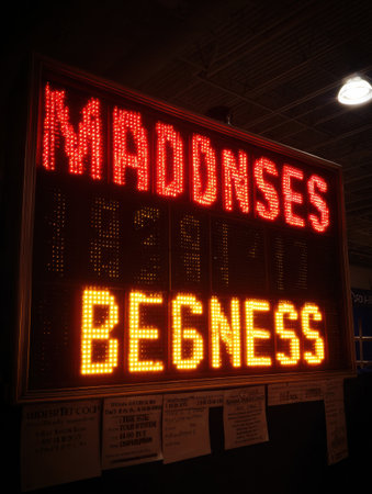 The glowing scoreboard indicates the countdown to the start of the event, building anticipation in a lively atmosphere with the phrase Madness Beginsの素材