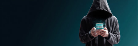 A hooded figure stands alone in a dimly lit environment, manipulating a fake banking app icon, embodying the clandestine world of cybercrime.の素材