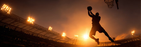 Silhouette of a player making an impressive basketball dunk while surrounded by vibrant stadium lights in the evening skyの素材