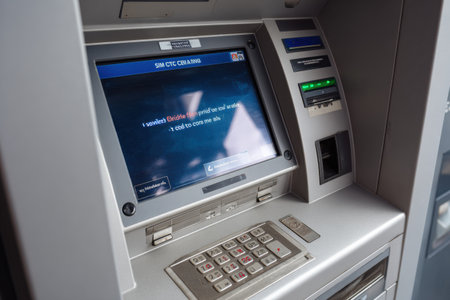 A touchscreen ATM shows a critical fault message while maintaining a clean layout, indicating a system malfunction in a busy urban area during daytime.の素材