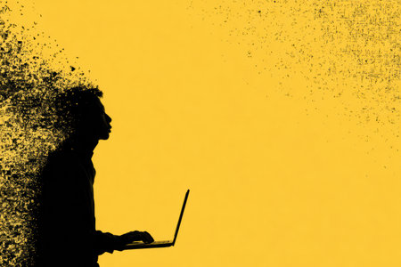 A silhouette of a frustrated user stands in front of a malfunctioning laptop with a yellow background, reflecting the challenges of technology-related stress.の素材