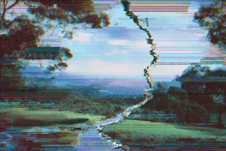 System error displays corrupted landscape with distorted colors and fragmented sections, revealing a scenic view of trees and a horizon in the background.の素材