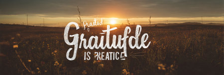 A warm, golden sunrise casts soft light over a tranquil field, featuring typography that emphasizes gratitude is a practice amidst natures beauty.の素材