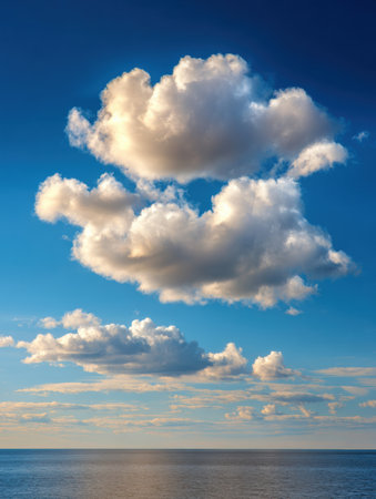 Tranquil clouds drift above the gentle ocean waves, reflecting a soft light that creates a soothing atmosphere and inspires mental clarity and reflectionの素材