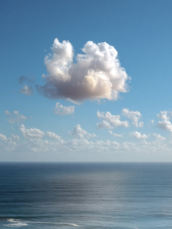 Calm ocean waters stretch to the horizon under a sky filled with soft clouds, evoking peace and a sense of mental clarity on a clear day.の素材
