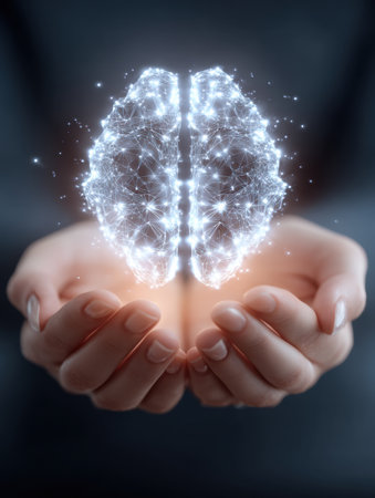 Hands support a glowing mind symbol, representing the importance of mental wellness and the interconnectedness of thoughts and emotions in personal growth.の素材