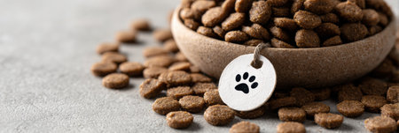 Grain-free kibble is prominently displayed in a bowl, surrounded by scattered pieces on a neutral background, emphasizing quality pet nutrition.の素材
