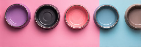 Colorful pet bowls arranged on a pastel background create a playful setup with ample space above for text or decoration, perfect for pet lovers.の素材