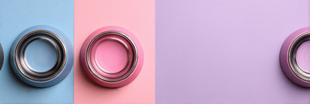 Two pet bowls are arranged on a pastel background, showcasing a creative setup with ample space above them for additional design elements or text.の素材