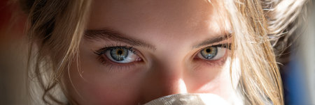 Engaging gaze in radiant backlight highlights the subject features, creating an intimate ambiance during a warm afternoon.の素材