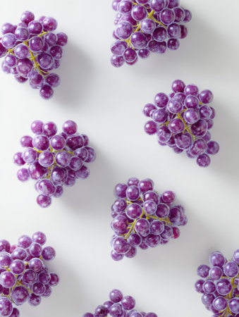Grapes cluster beautifully on a soft white background, highlighting their vibrant color and design potential for decor or branding.の素材